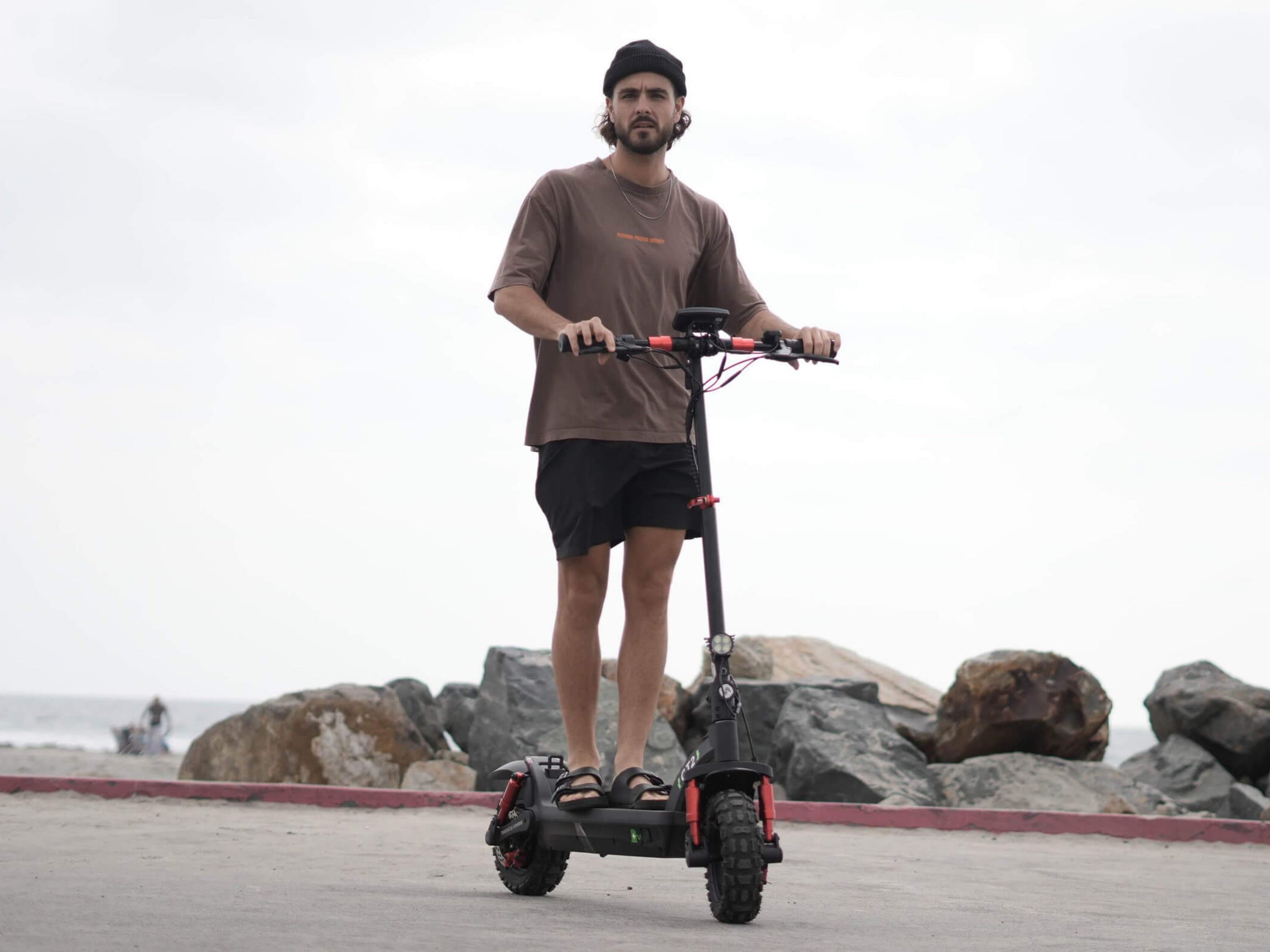 Rider on an iSinwheel GT2 on a rocky shoreline path